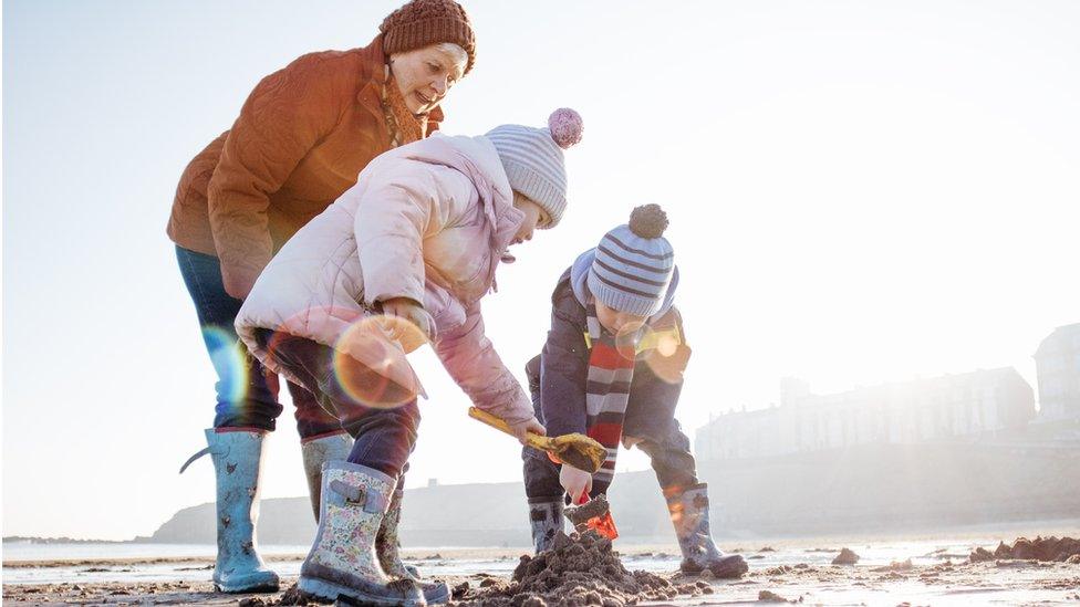 grandmother with children on the beach