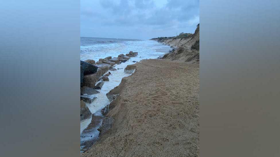 View of the water coming in behind the defences and washing away the ramp used by the lifeboat