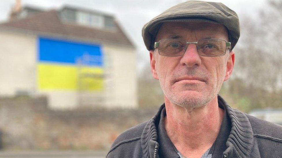 Simon Broadhead in front of his house