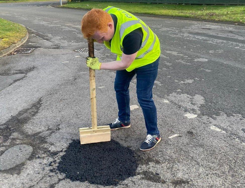 Luke Mason appearing to repair a pothole