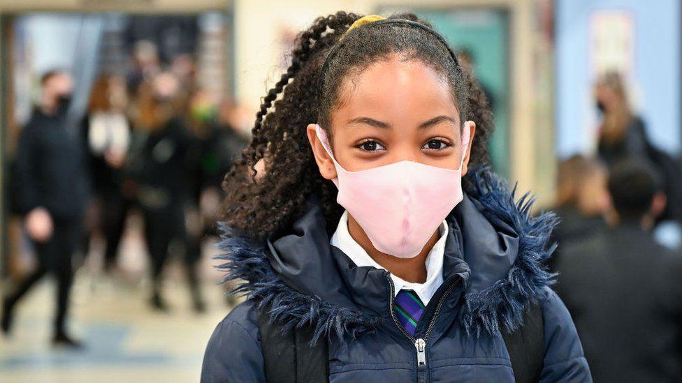 Pupil wearing coat and facemask