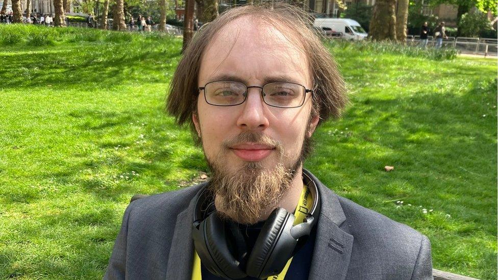 Duncan Abrahart standing in a city park in the sunshine