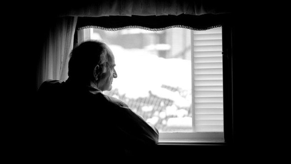 Man looking out the window