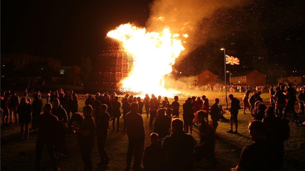 People watch the bonfire at Hopewell Square in Belfast's Shankill area