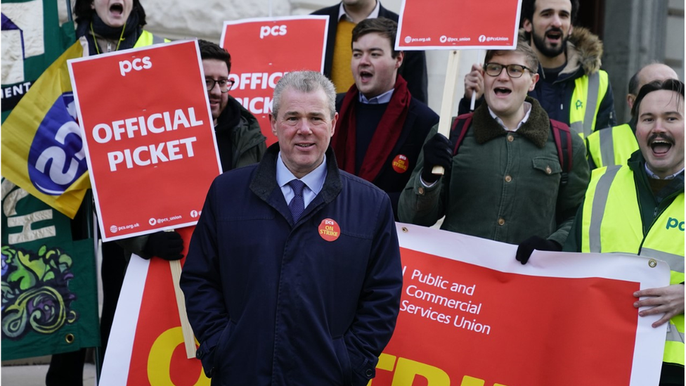 Secretary of the PCS union, Mark Serwotka (centre), joins union members on the picket line outside the office of HM Treasury, in Westminster