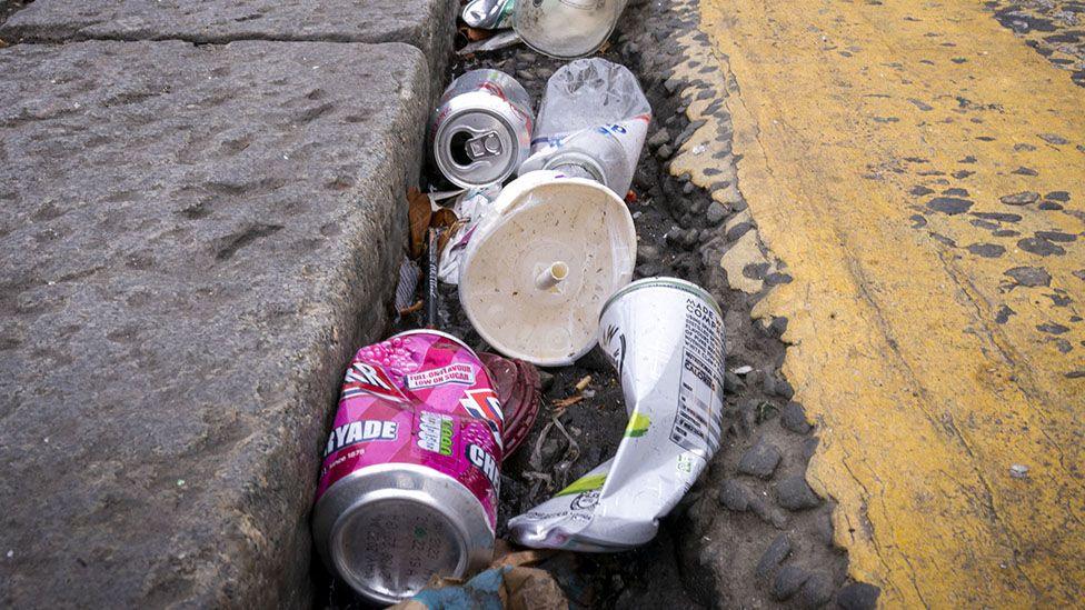 Generic close up image of rubbish - empty cans at the side of a road