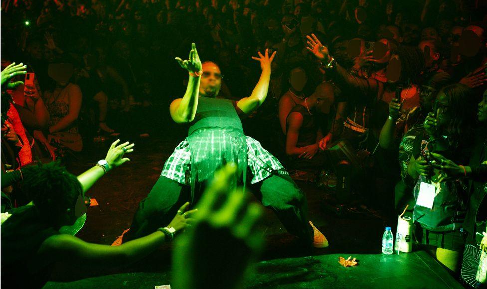 A man in a kilt dancing on stage