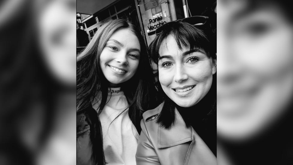 A black and white selfie-style portrait of Jaysley Beck, left, and Leighann McCready. Both are wearing coats and Ms McCready has sunglasses on her head.
