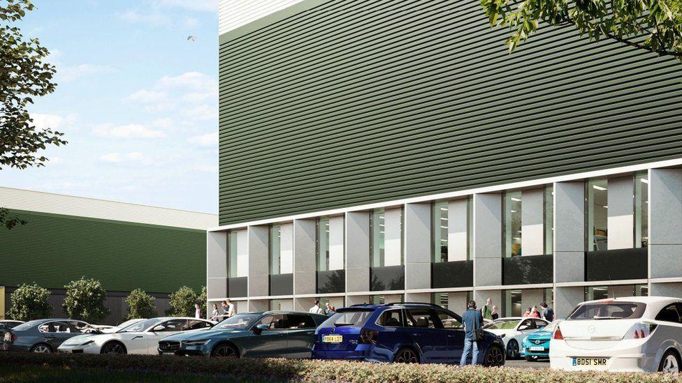 An artist's impression of a green and white warehouse building, with ground-floor windows and a car park outside with some trees. There are cars and people in the foreground.