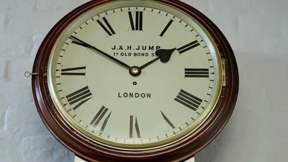 A traditional clock sitting against a plain white background