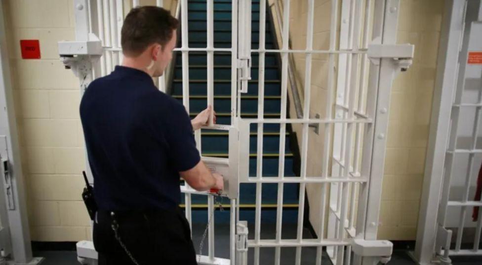 Prison officer closes prison door