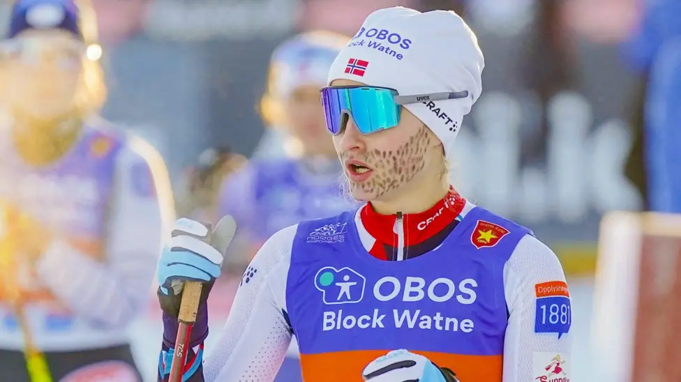 Norway's Gyda Westvold Hansen competes with a beard painted on her face as she protests for inclusion in Winter Olympics at a 2022 World Cup event in Norway