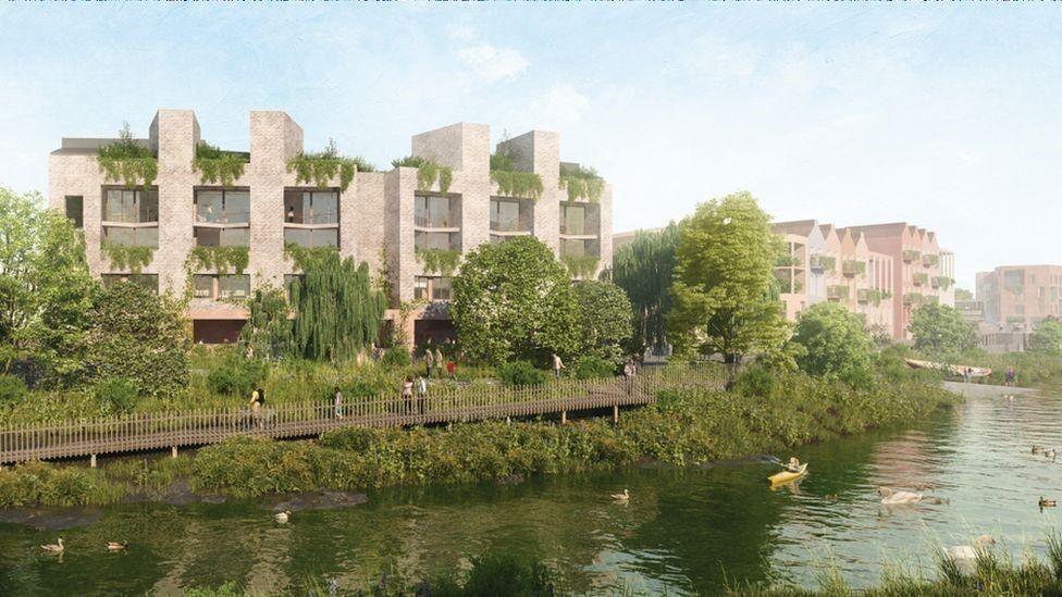 A CGI image of buildings by a river with lots of trees lining the river bank.