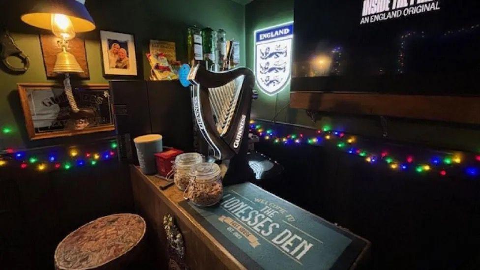 A homemade bar with a Guinness pump and England badge