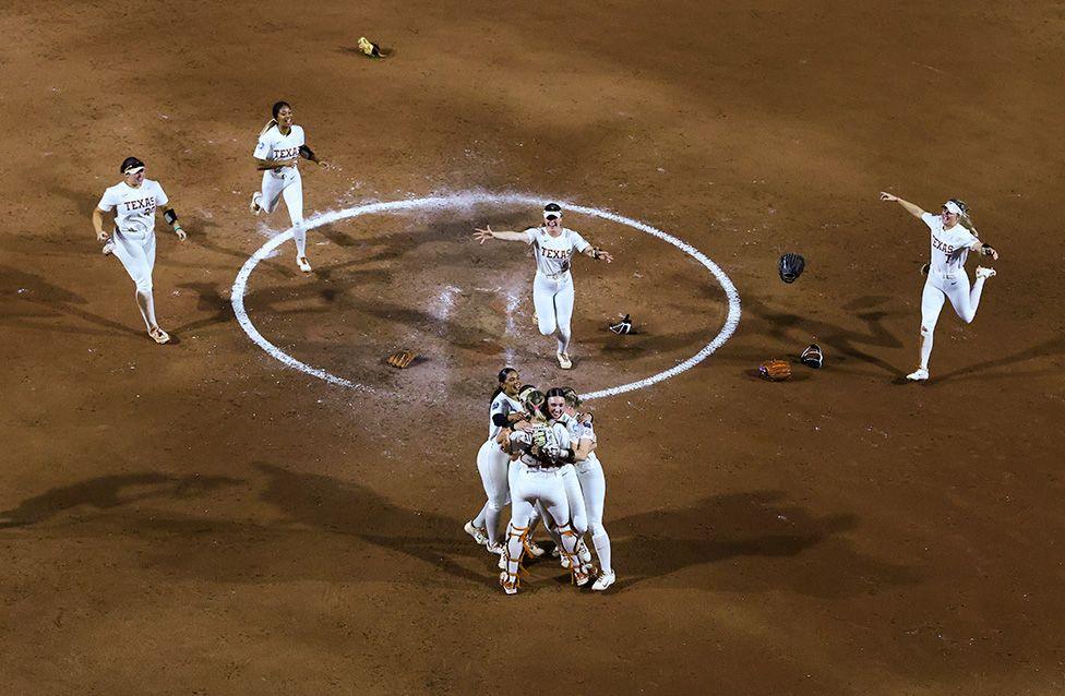 The Texas Longhorns celebrate after defeating the Texas Tech Red Raiders to win the Division I Women's Softball Championship series in Oklahoma City. Photo by Justin Tafoya