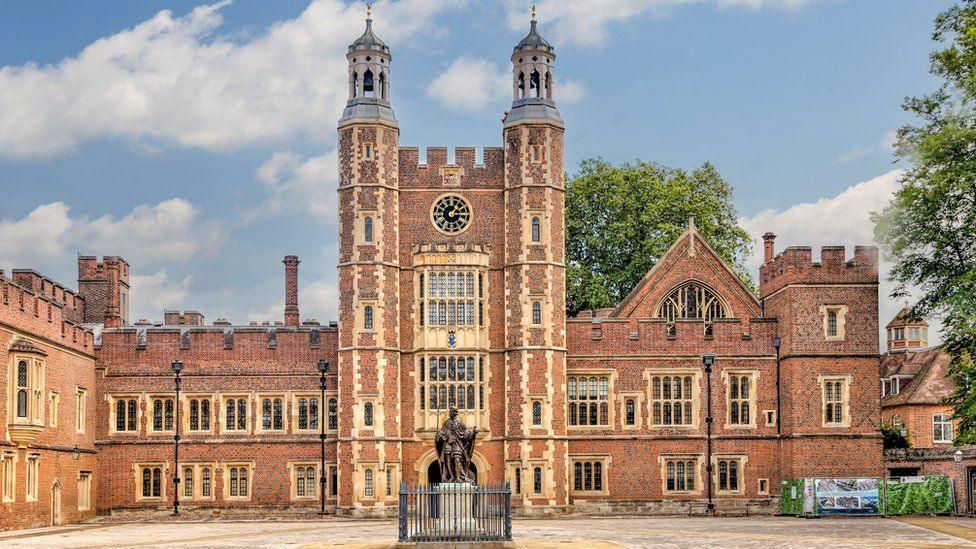 The main courtyard on the campus of Eton College red brick facade with cream inlays to windows and a statue centre