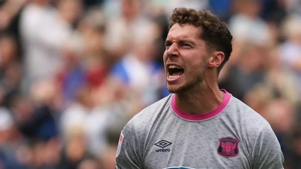 Mansfield Town sign goalkeeper Harry Lewis from Carlisle United on an 18-month deal for an undisclosed fee