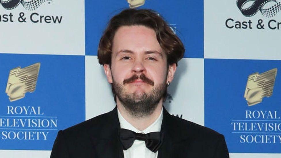 Nick Stapleton attends the Royal Television Society Programme Awards at The Grosvenor House Hotel on March 26, 2024, London. He has dark hair and a dark beard and is wearing black tie.