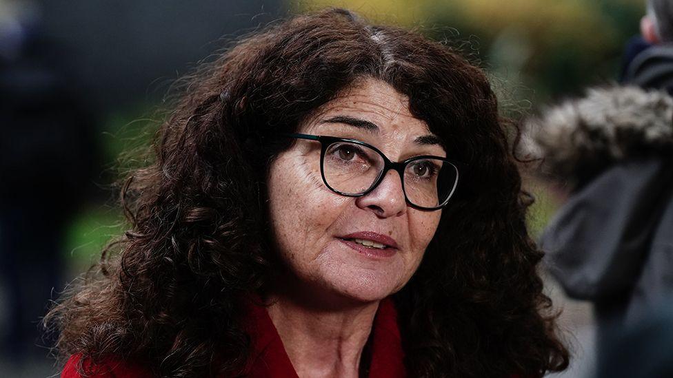 Close-up image of policing minister Dame Diana Johnson wearing glasses and a red jacket