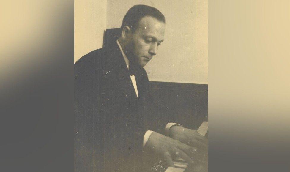 A black and white image of a musician at a piano