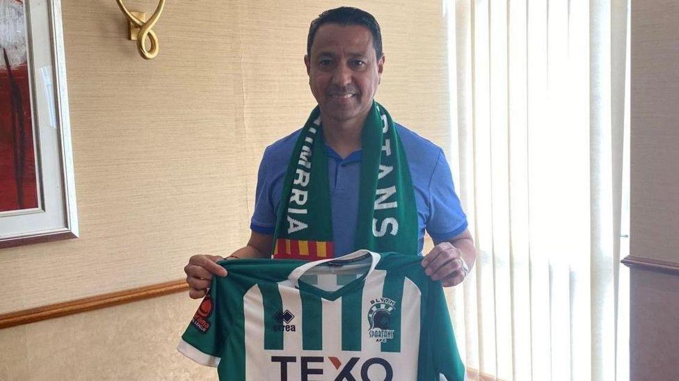 Nolberto Solano holds up a Blyth Spartans shirt after his appointment in May.