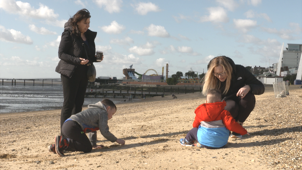 Julie Noble and Hayley Webb playing with children on Southend beach