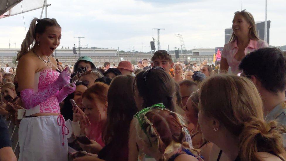 Caity stands with fans at Reading