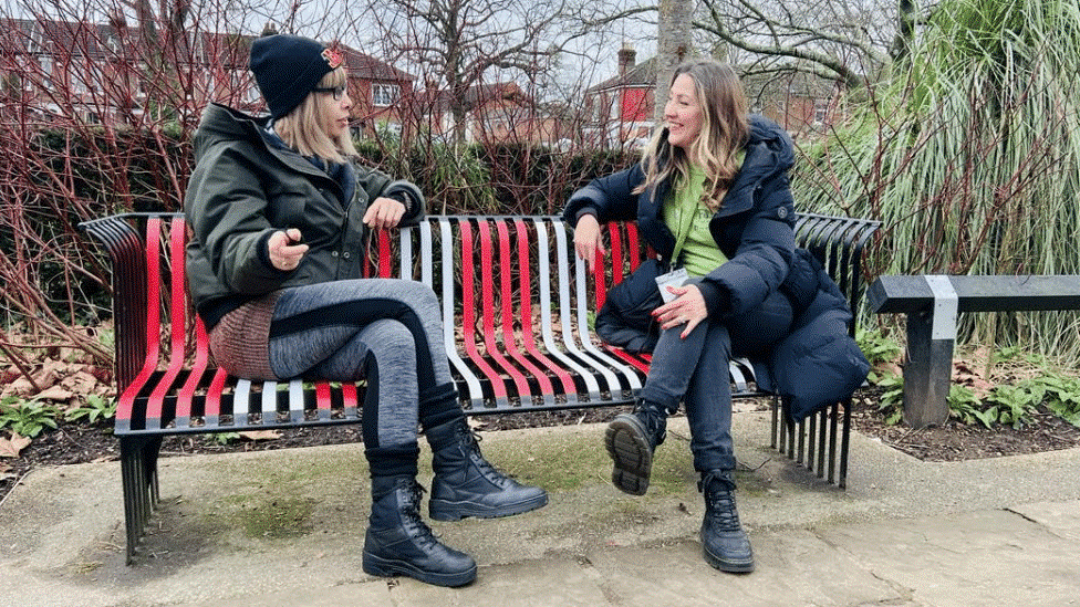 Sue Kinch on the right (Friends of St. James Park) sat on the new red & white talking bench in Southampton’s St. James Park