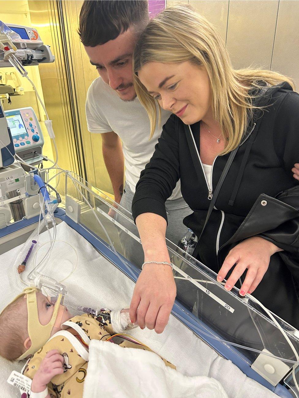 Daisy with her parents Ronnie and Emma in hospital