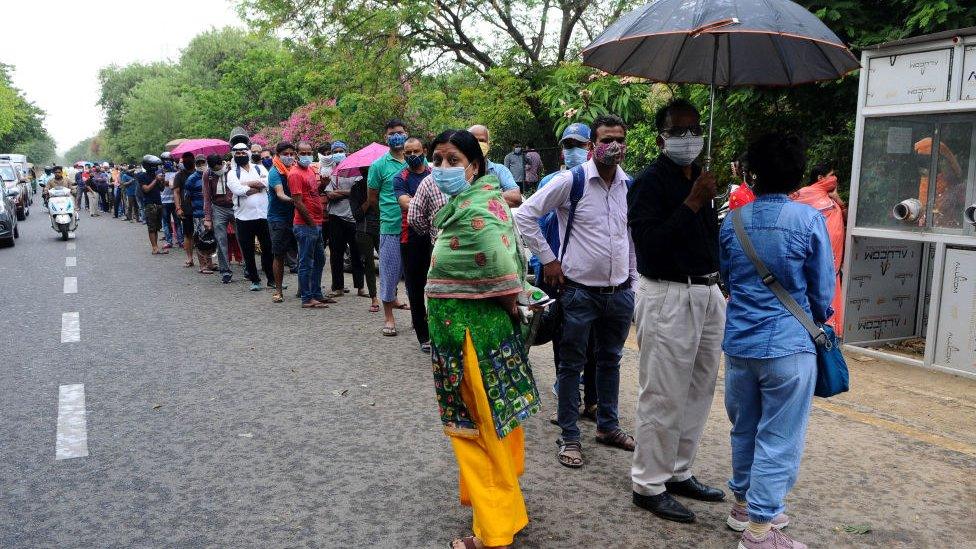 People wait in queue for their turn for COVID-19 testing at a test centre at Ghaziabad in Uttar Pradesh, India on April 23, 2021