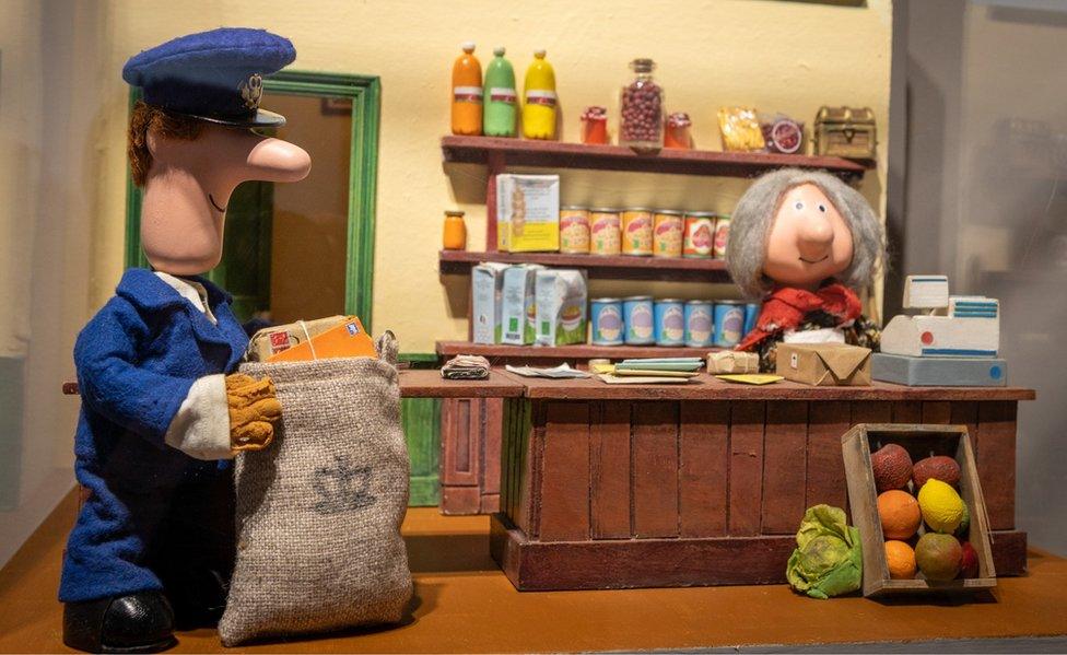 Postman Pat and Mrs Goggins in a shop