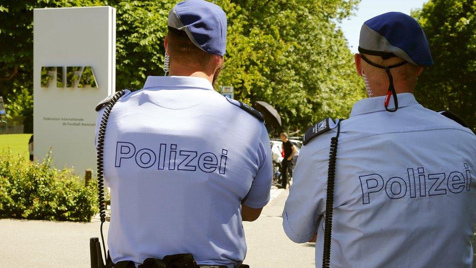 Swiss police officers stand in front of the entrance of the FIFA headquarters in Zurich, Switzerland on 3 June