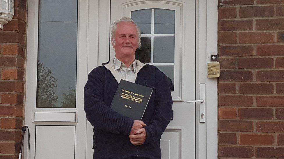 Historian Francis Salt standing outside his house