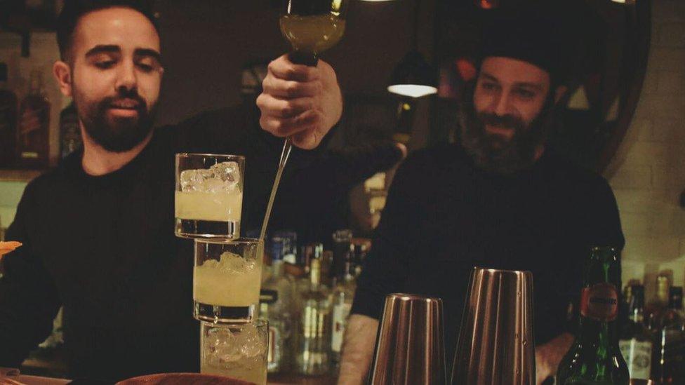 Bartender in Cosette pouring drinks