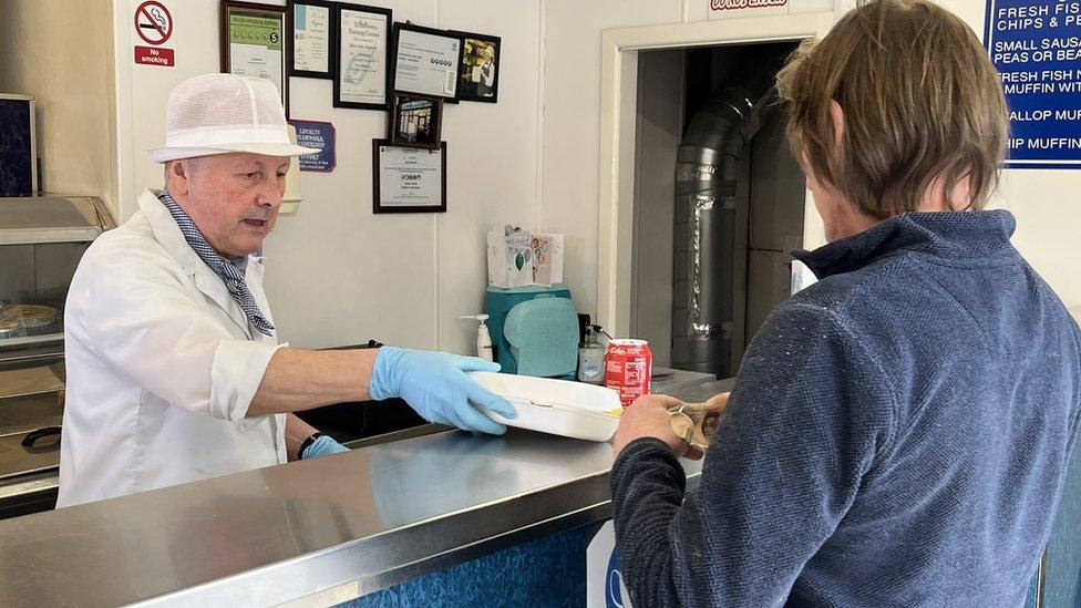 Peter Singleton serving a customer