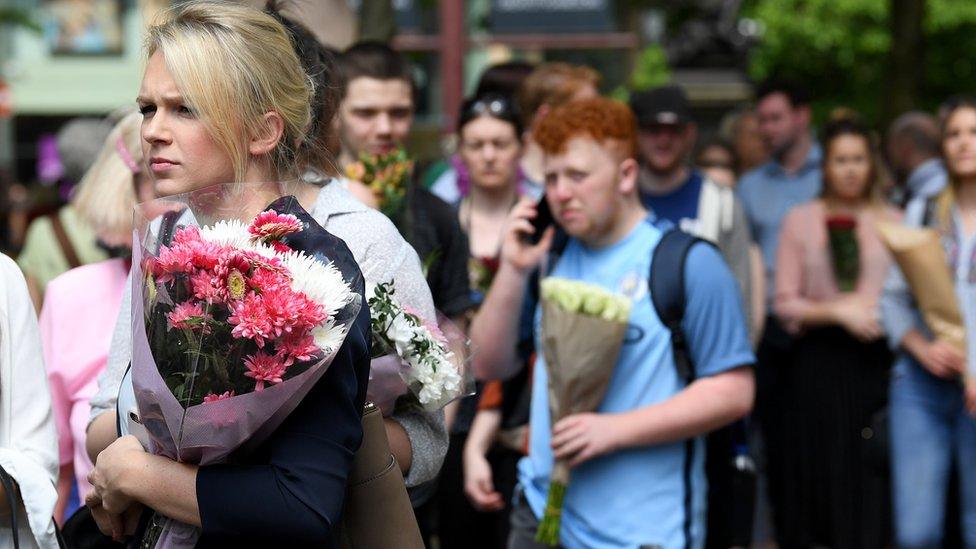 People queuing to give flowers