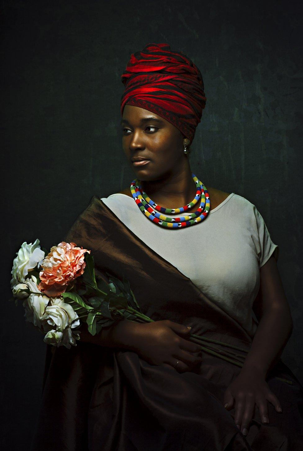 Portrait by Alanna Airitam showing a woman holding flowers