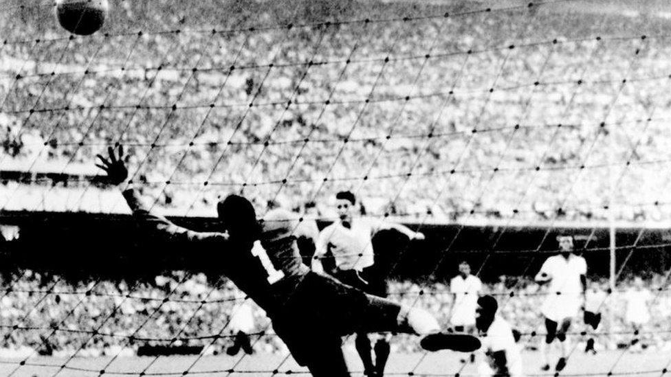 RIO DE JANEIRO, BRAZIL - JULY 16: Uruguayan forward Juan Alberto Schiaffino (C) kicks the ball past Brazilian goalkeeper Moacyr Barbosa to level the score during the World Cup final round soccer match between Uruguay and Brazil 16 July 1950