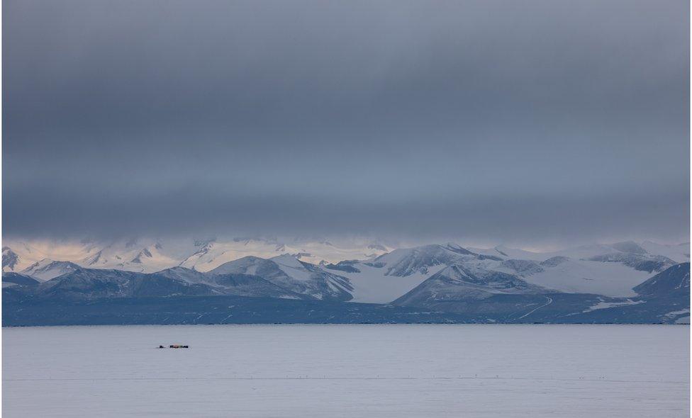 Antarctic landscape with mountains and tents