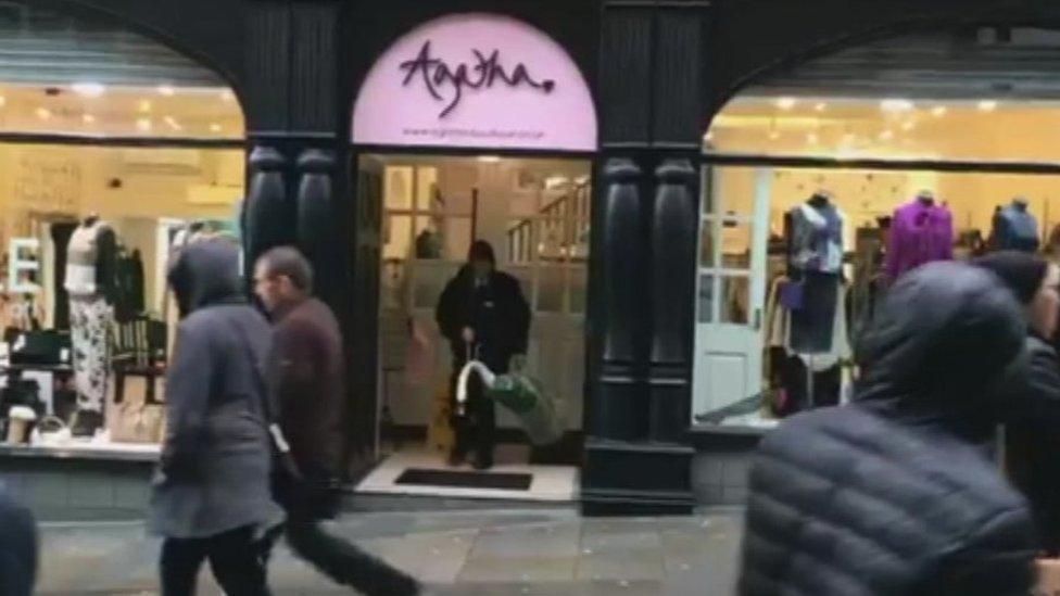 The swan and the RSPCA worker walking out of Agatha Boutique