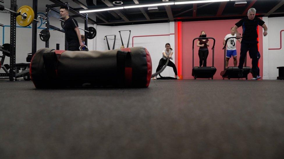 woman pulling sand bag