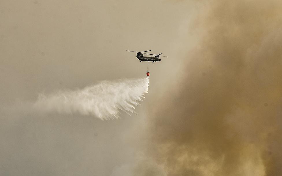 A military Chinook helicopter flies over the area of Magoula, near Athens, Greece