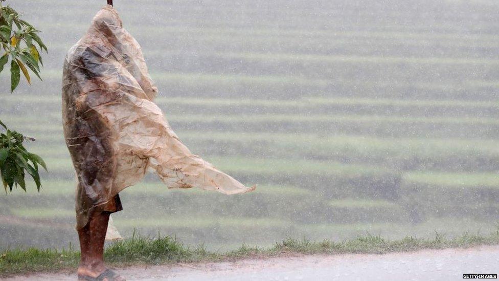 A photo of a man standing in rain