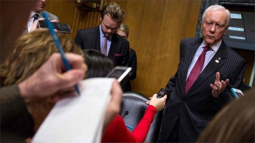 Sen. Orrin Hatch (at right) (R-UT) speaks speaks to reporters after calling a recess during a Senate Finance Committee meeting on February 1, 2017.