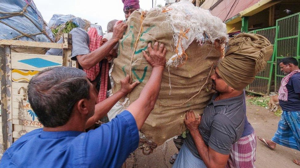 Workers at a farmers market in India