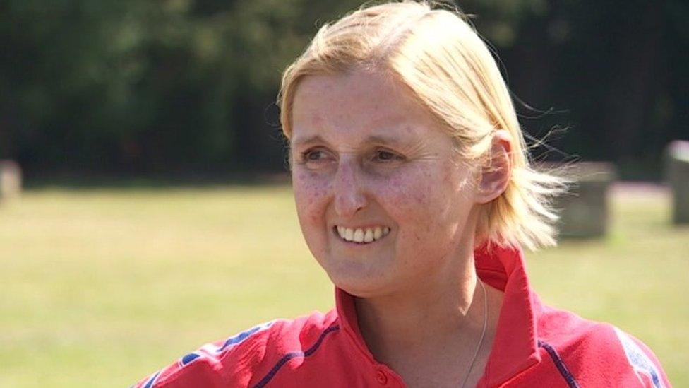 Katrina Brown, who has short blonde hair, in red shirt, smiling.