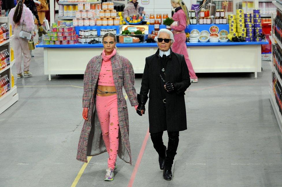 Fashion Designer Karl Lagerfeld and model Cara Delevingne appear at the end of the runway during the Chanel show as part of the Paris Fashion Week Womenswear Fall/Winter 2014-2015 on March 4, 2014 in Paris, France.