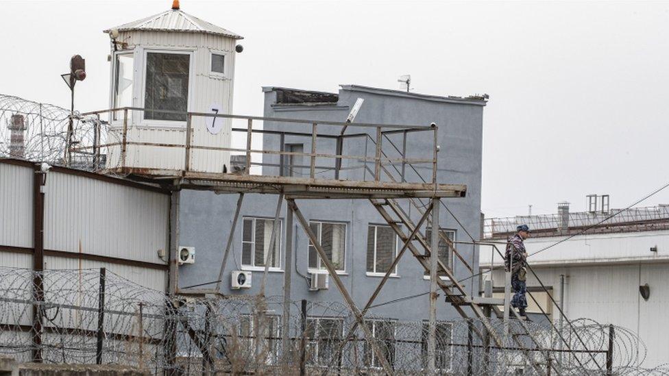 A colony guard goes down stairs in penal colony No.3 (IK-3) of the Federal Penitentiary Service Directorate for the Vladimir region, where the regional hospital for convicts is located, in the town of Vladimir