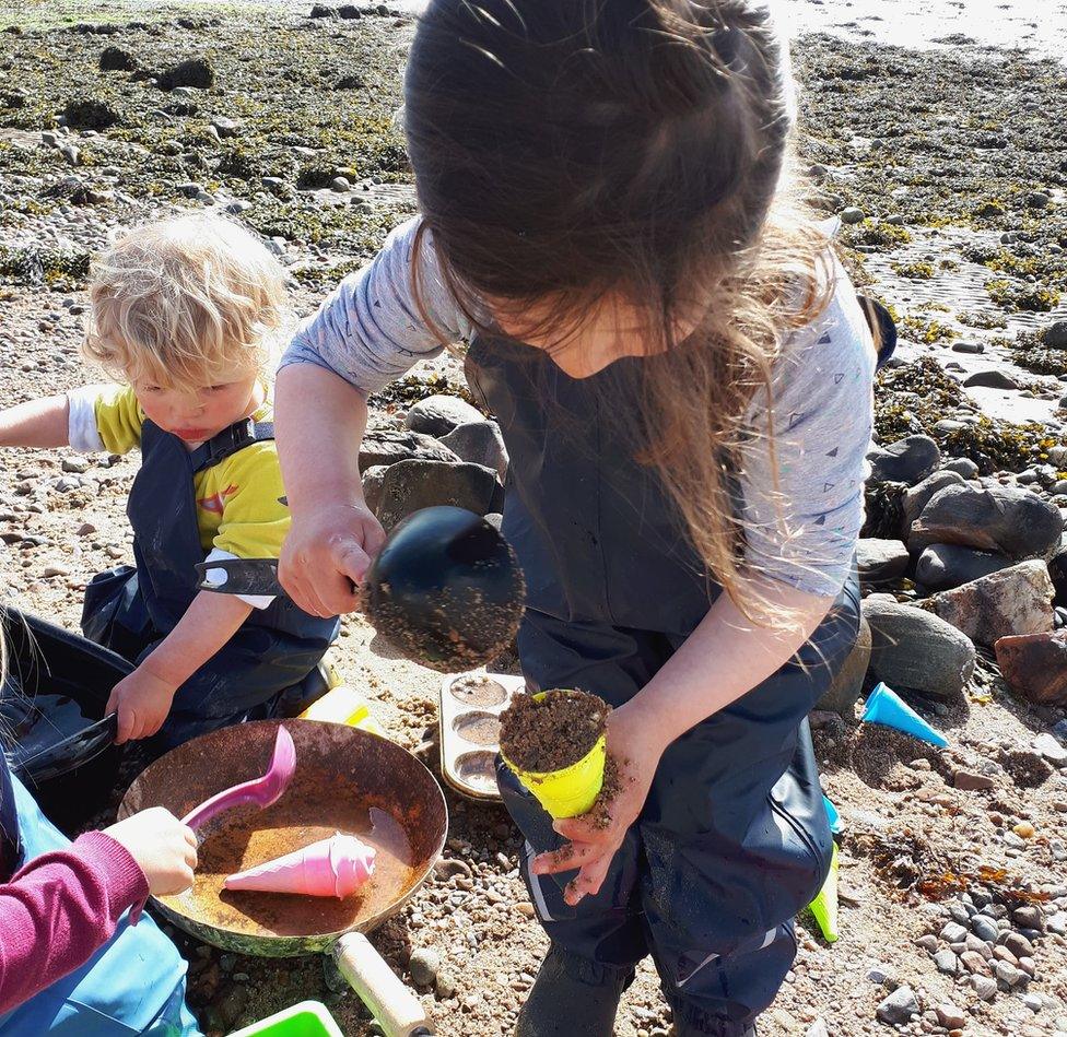 Children playing in sand on a beach