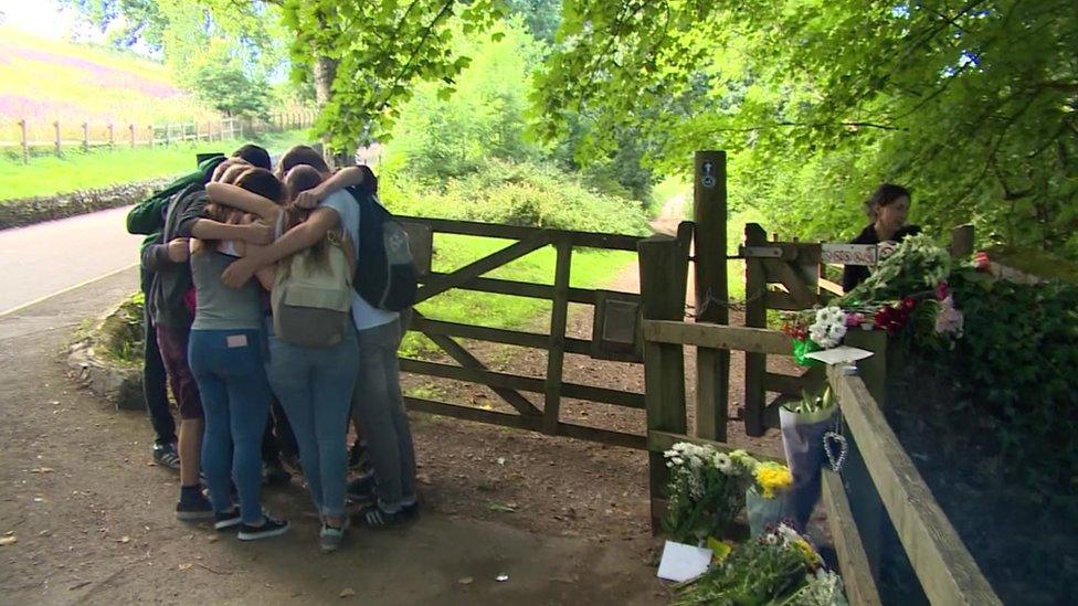 Nathan's friends hugging at the Rivert Dart